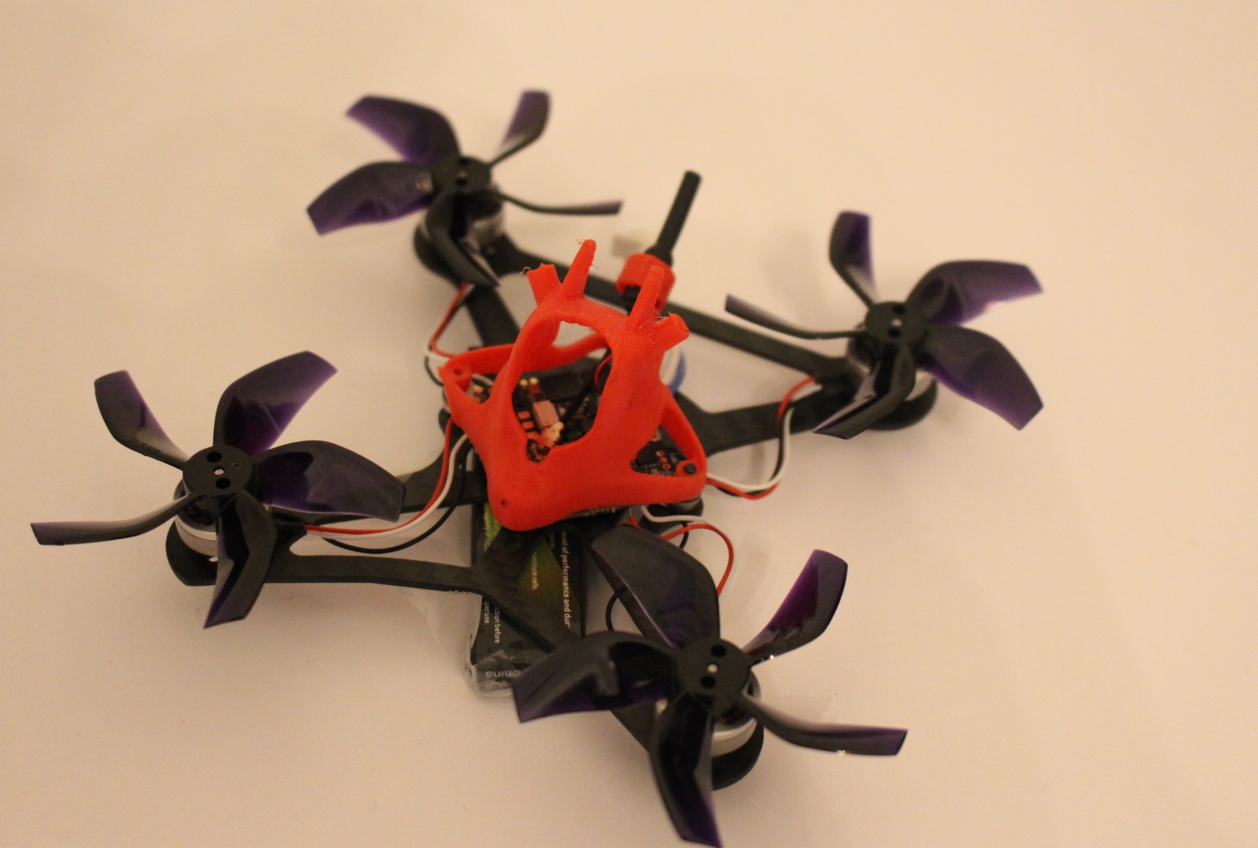 Custom-built micro racing drone with 3D-printed flight controller mount